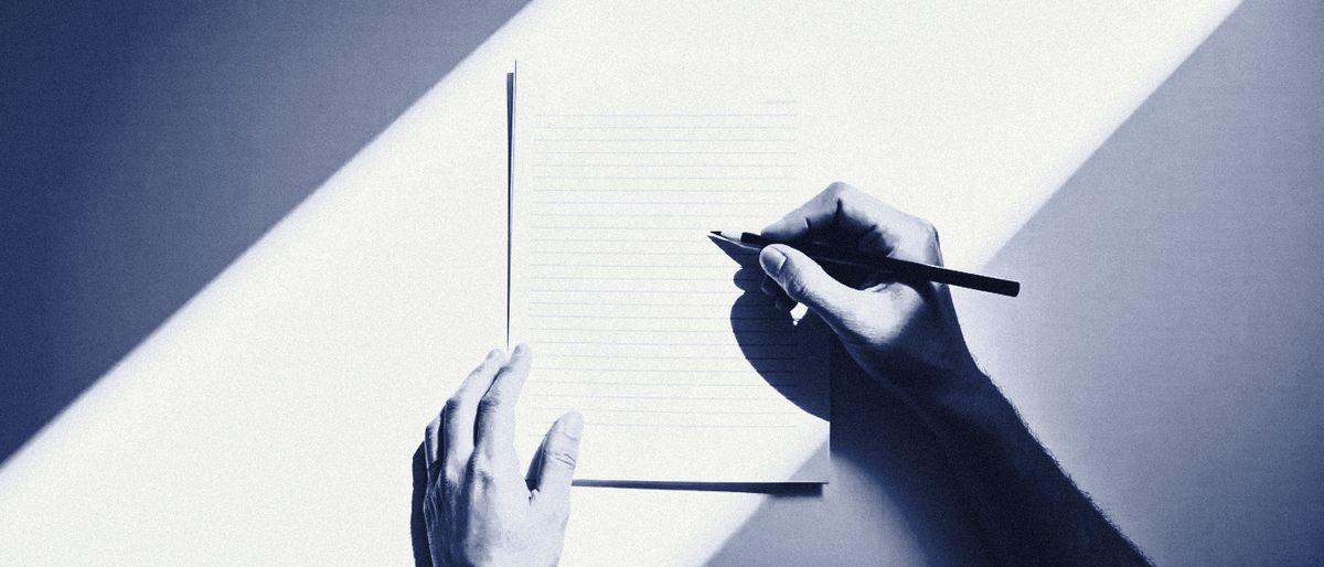 Two hands over a printed page, a pencil resting under one line as someone reads it closely.